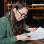 Consumer reviewing monthly expenses after relying on credit for groceries and household essentials