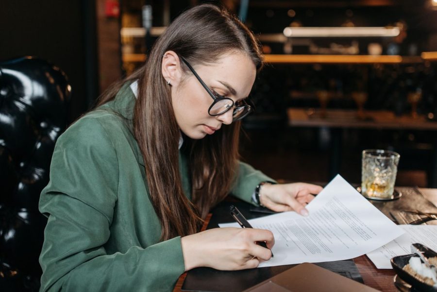 Consumer reviewing monthly expenses after relying on credit for groceries and household essentials