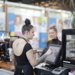 Business owner comparing point of sale software options on a computer