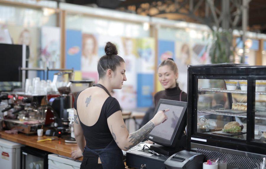 Business owner comparing point of sale software options on a computer